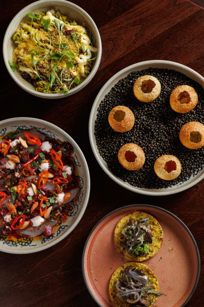 Selection of Indian starters at Tanvi, an Indian restaurant in St George’s Bay Malta, featuring bhel puri, pani puri, cured sea bream and rabbit keema samosa.