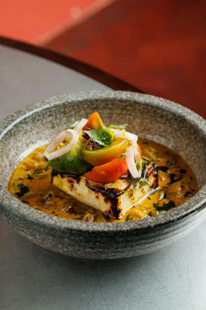 Grilled malai paneer served at Tanvi, an Indian restaurant in St George’s Bay Malta, with creamy tomato sauce and basil.