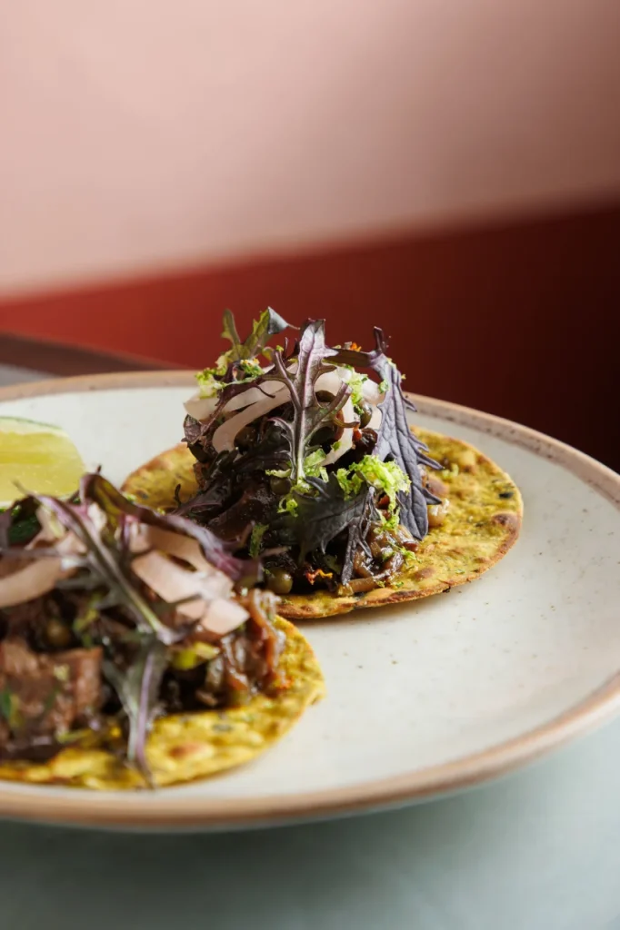 Kerala beef tacos served at Tanvi, an Indian restaurant in St George’s Bay Malta, featuring spiced beef, thepla roti and fresh herbs